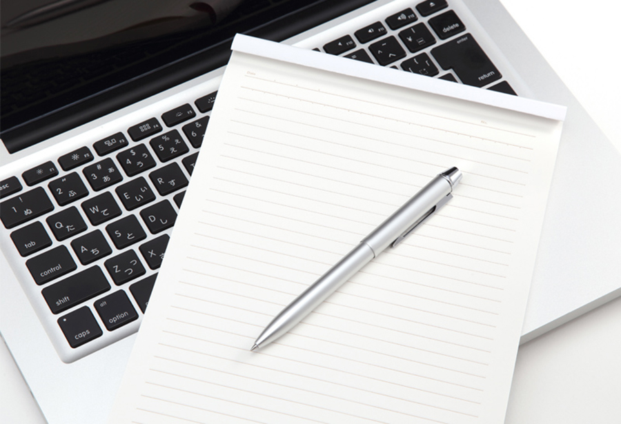 ノートパソコン、ペン、レポート用紙の画像